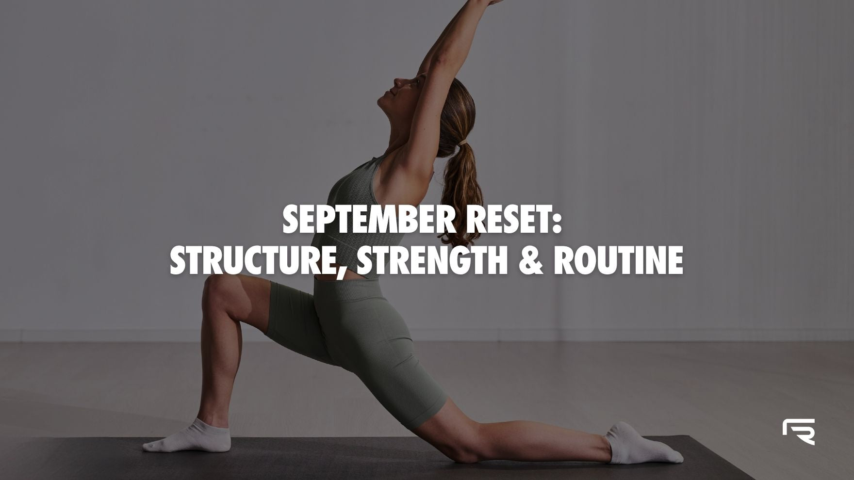 September Reset: Structure, Strength & Routine Blog Post. Instructor in a stretch on yoga mat.
